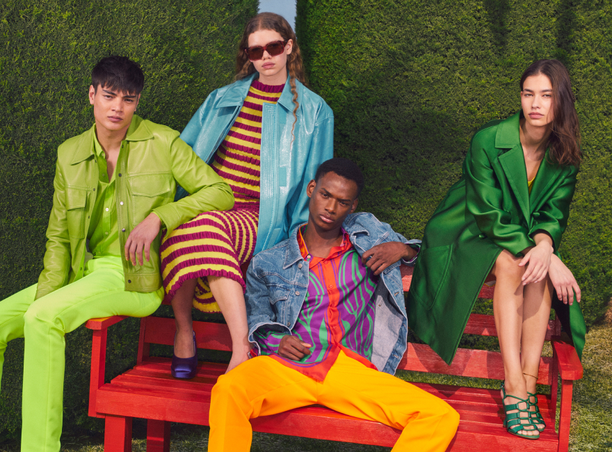 Group of sitting models wearing Yoox colourful outfits