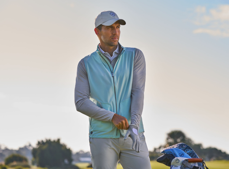Model playing golf with a blue jacket 
