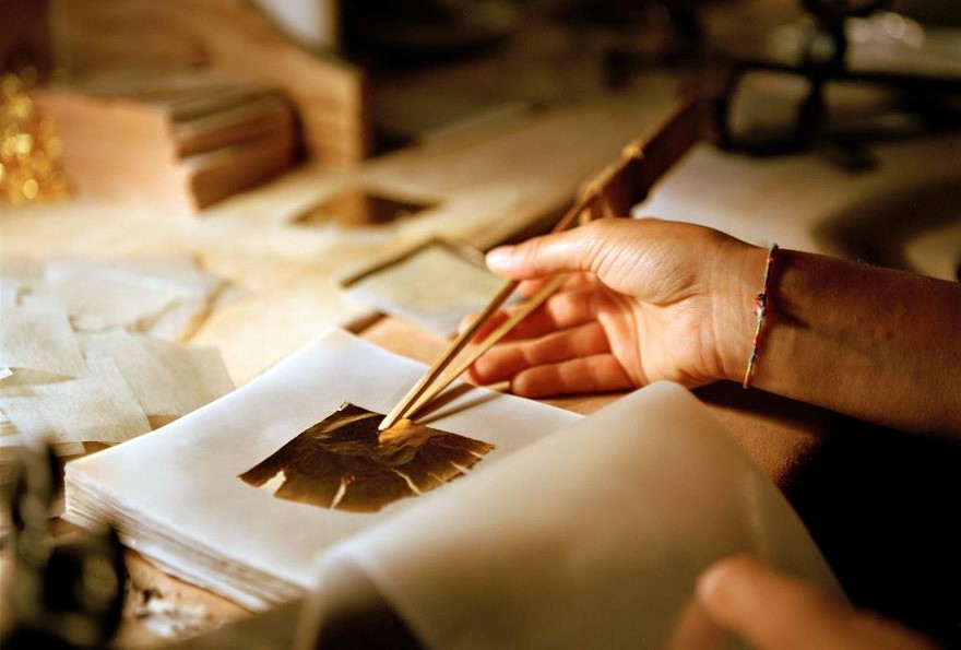 A craftsman working on a piece of gold