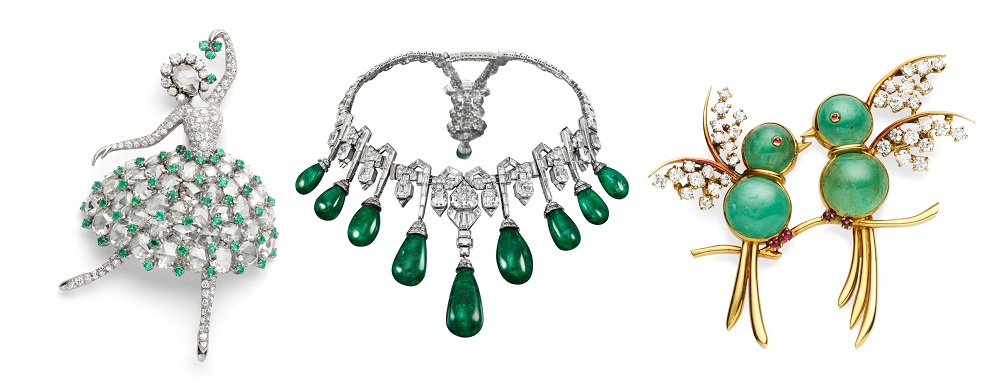 Two pins and a necklace encrusted with diamonds and emeralds