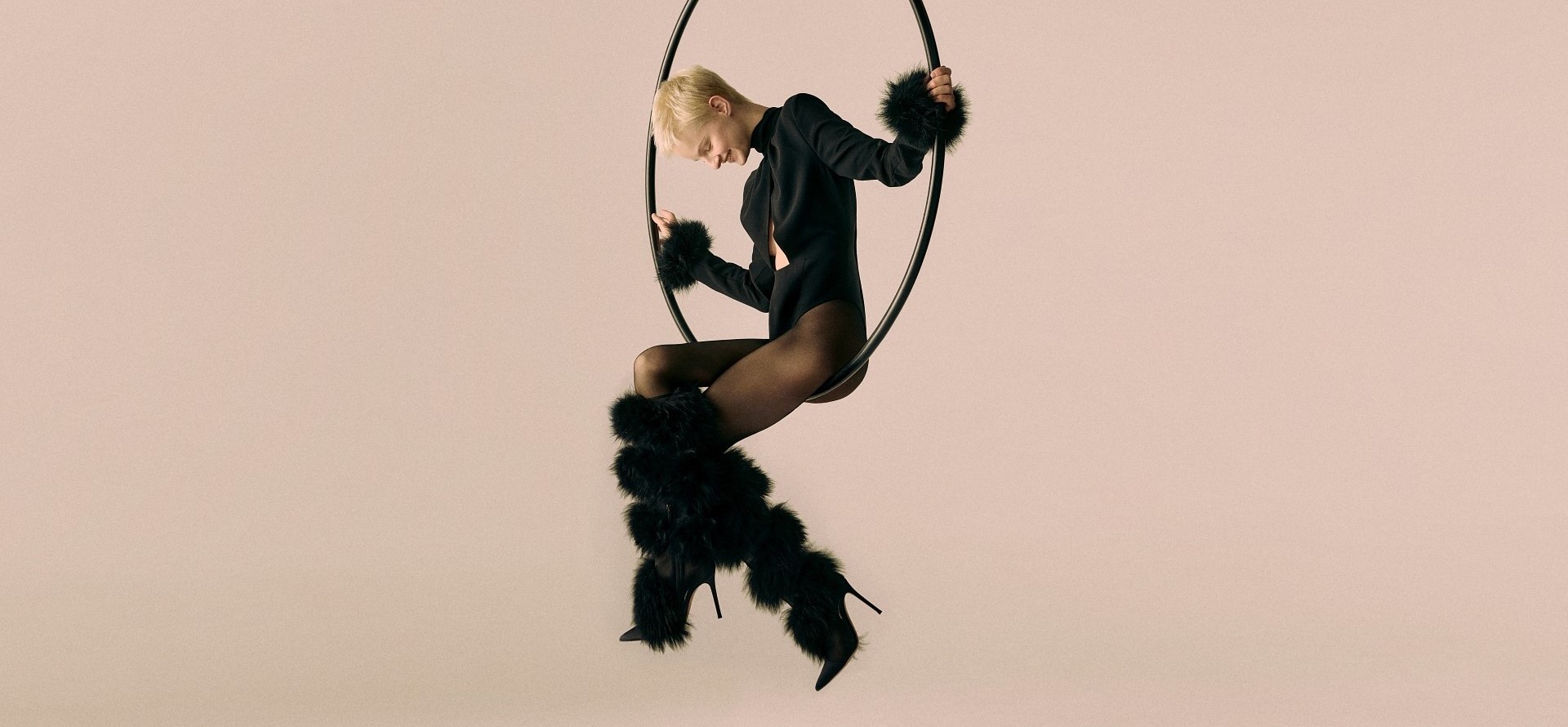 A woman with furry boots sitting on a swing