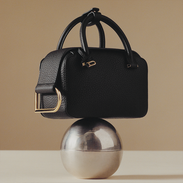 Delvaux black bag on balanced on a silver ball 