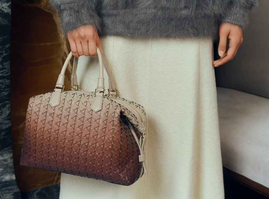 A woman holding brown ombre bag