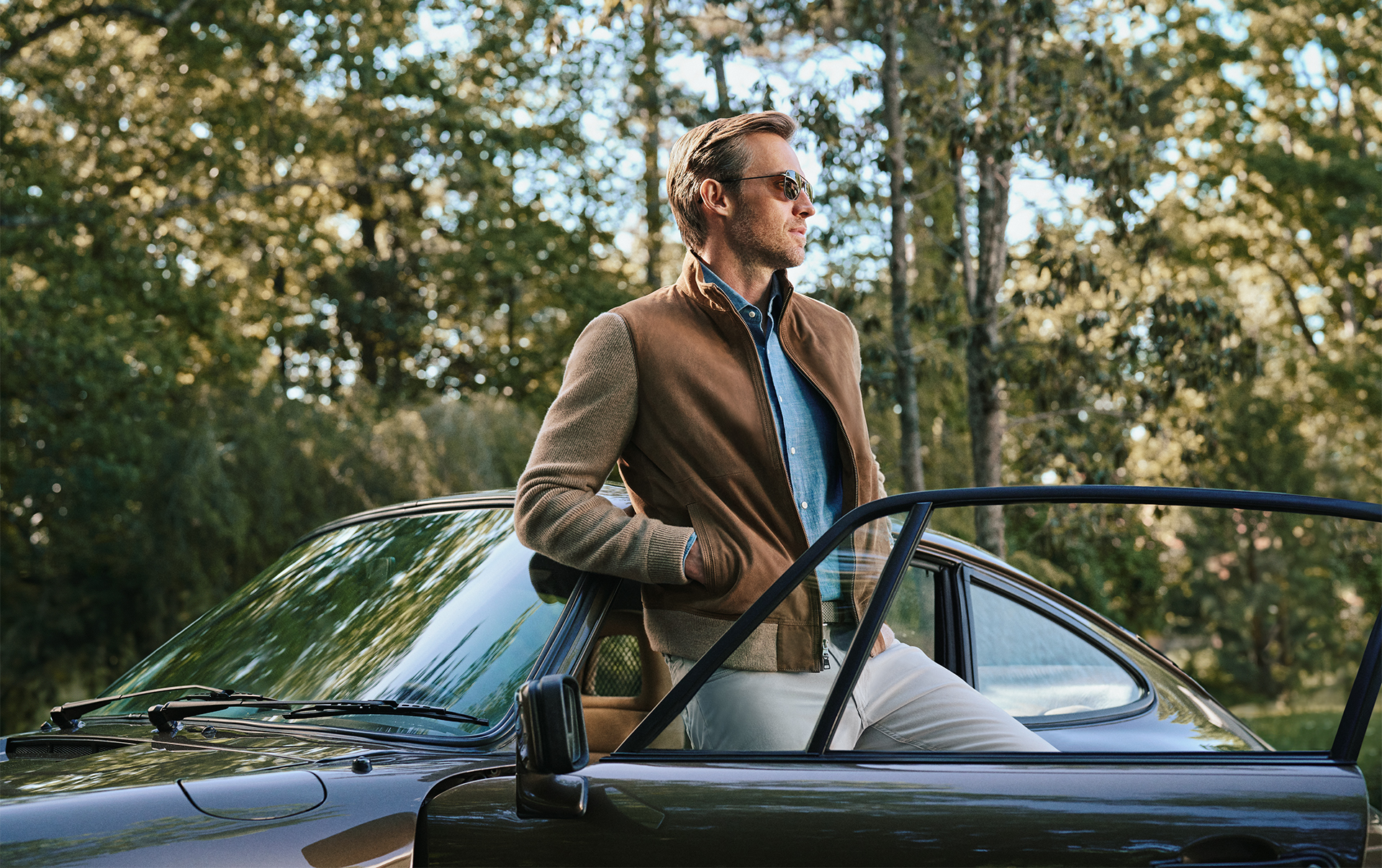 Man in glasses standing by a car