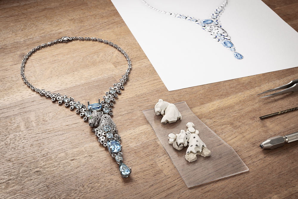 A necklace with a panther, encrusted with diamonds and blue gemstones, with a sketch in the background